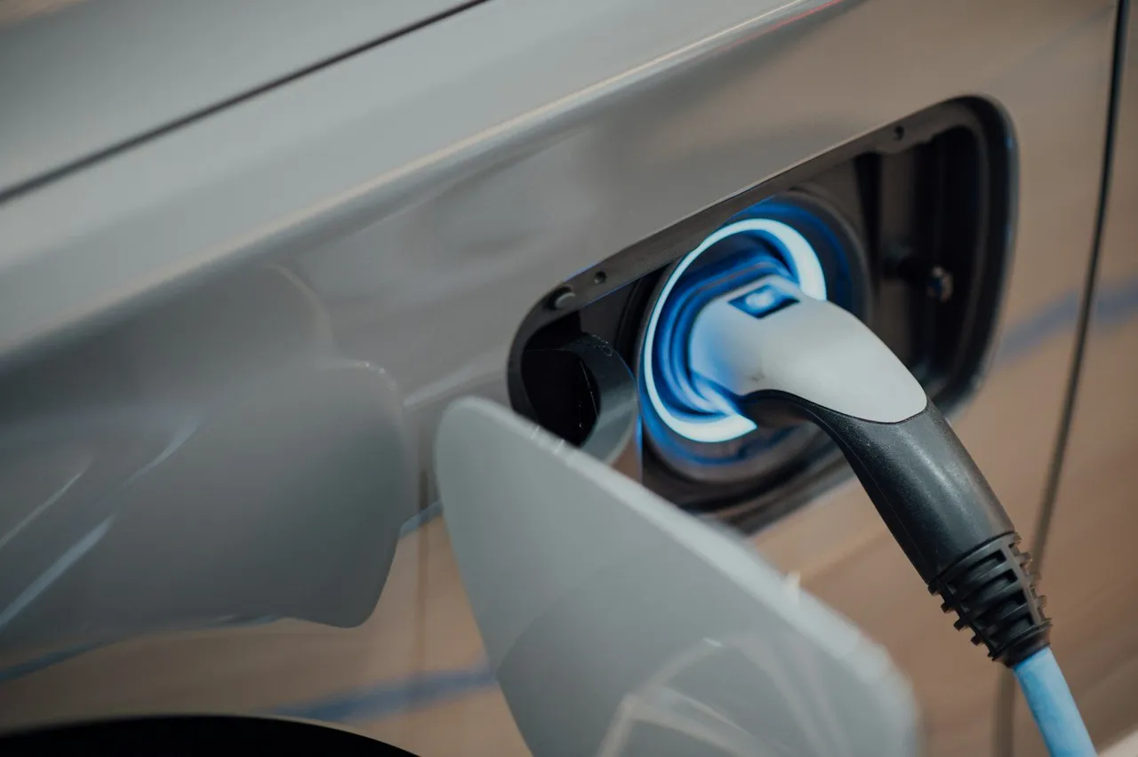 EV charging cable connected to a vehicle — NEOM residential / كابل شحن سيارة كهربائية — نيوم