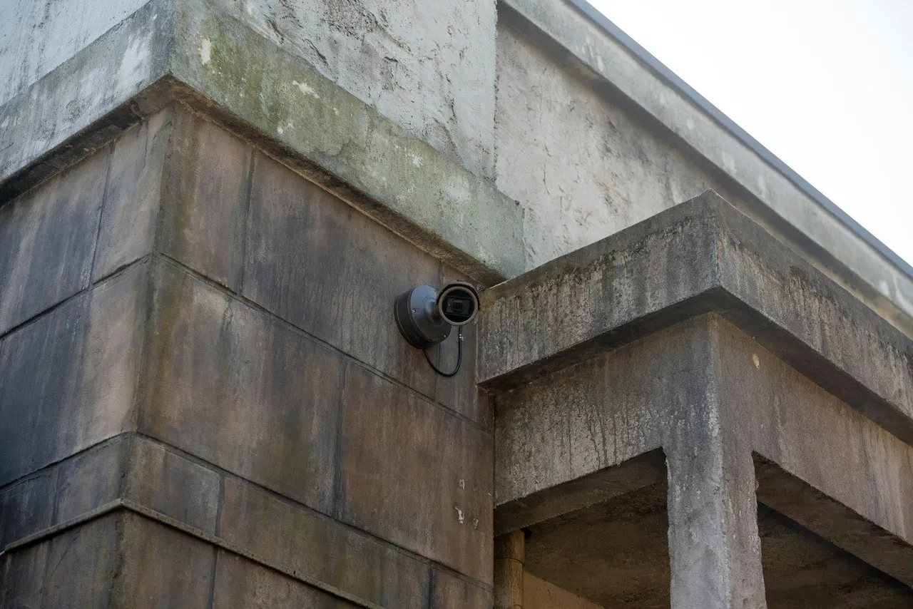 Modern surveillance camera on building facade